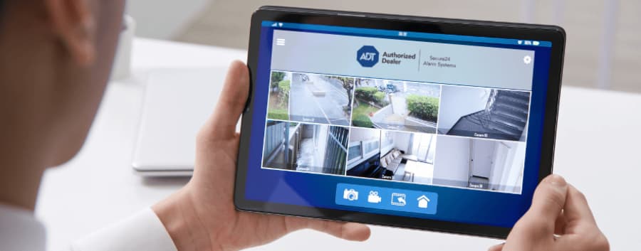 Homeowner checking out camera footage on a mobile device